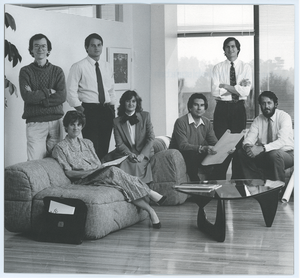 Steve jobs and his team at NeXT in an office space with modern furniture.